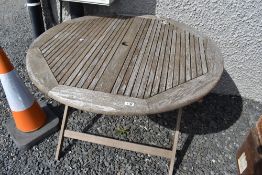 A folding teak garden table