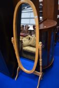 A vintage beech frame oval cheval mirror