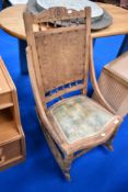 A 19th Century rocking chair having stripped frame