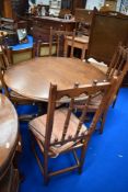 An Ercol colonial style extending dining table and set of four similar dining chairs