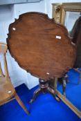 A 19th Century mahogany pedestal occasional table having shaped top , turned column and triple splay