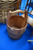 A vintage wooden milk pail