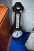 A traditional aneroid barometer , with thermometer scale