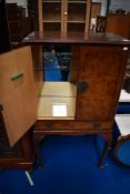 A mid 20th Century walnut cocktail cabinet