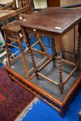 An early 20th Century oak occasional table having barley twist legs