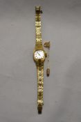 A ladies Rotary wristwatch and a gold coloured pin brooch in the form of a knot