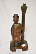 A continental novelty corkscrew and bottle opener, in the form of a smoking gentleman beside a