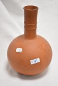 A nicely turned and proportioned terracotta vase, with slender knopped neck over the globular