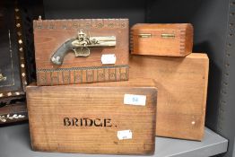Four novelty and other wooden boxes, to include a version decorated with a flinklock pistol