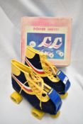 A pair of children's vintage roller skates, marked 6 to base, with their original box