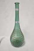 An interesting green glass vase, having dimple decoration, long neck, and measuring 40cm tall
