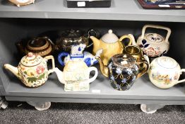 An assorted collection of teapots, of different designs and ages, to include a cottage ware