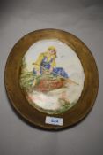 A hand painted plate of oval form, depicting shepherdess to centre.