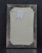 A George V silver photograph frame, of rectangular form with engine-turned decoration and shaped