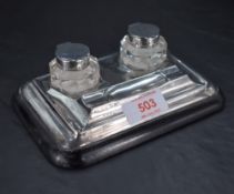 A George V silver, glass and ebony ink stand with two removable silver topped and facet-cut glass