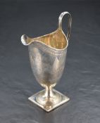 A William IV silver cream jug, of elongated helmet form with shallow spout and looped strap handle