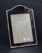 A George V silver and tortoiseshell photograph frame, of arched rectangular form with material