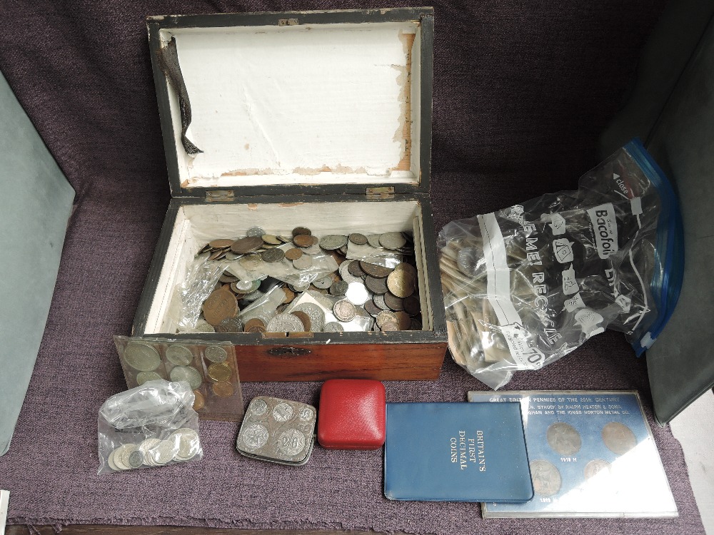 A collection of World Coins including a small amount of Silver, modern Crowns, tin Coin Holder,