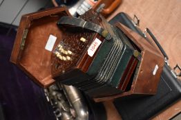 A late 19th/early 20th Century mahogany cased concertina with fretwork decoration, numbered 74300