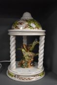 A mid century Derek Fowler lamp base, in the form of a garden pagoda with birds to centre.