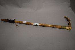 An early 20th century horn handled riding crop, having Eve Cook monogrammed to cuff.
