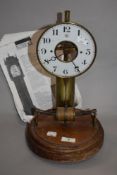 An early 20th Century French Bulle electric clock, the large brass column supporting an enamelled