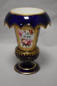 A 19th century footed vase with down turned cuffed neck, having cobalt blue ground and floral