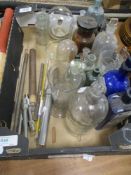 A box of apothecary bottles, measures and similar, including green glass and blue poison bottles.