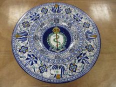 A continental charger, having Portuguese styling, with serpent, crown and wreath to centre and