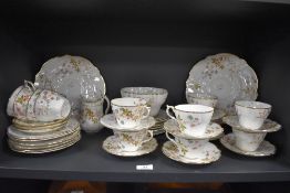 A Victorian hand painted tea set, decorated with floral sprays and heightened with gilding