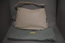 A large Radley handbag in pale pink, as new with tags, having beaded detail to side.