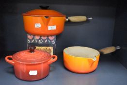 Two Le Creuset saucepans and a casserole dish.