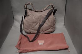 A Radley leather pale pink hand bag together with a drawstring bag