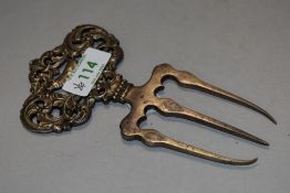 A Victorian meat/ bear claw fork, having pig to centre with filigree decoration surrounding.