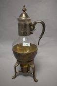 A vintage glass and plated metal tea/ coffee carafe, having receptacle to underside to hold a candle