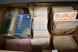 A selection of various decorative ceramic tiles, some retaining the original packaging.