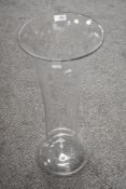 A modern large floor standing hand blown glass vase of fluted bell form 60cm tall.