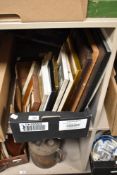 A carton containing an assortment of pictures and frames.