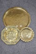 An antique Indian brass table top tray with two similar brass trays.