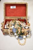 A shell encrusted jewellery box containing various jewellery, to include synthetic pearls, and other