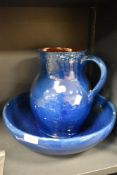 An earthenware jug and basin set, having blue and brown glaze, AF.