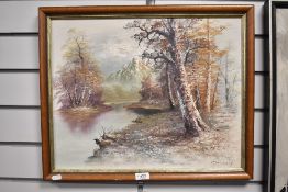 A 20th century oil on canvas, winter woodland scene with river and mountains, nondescript