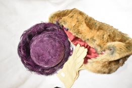 A pair of vintage suede gloves, a 1960s purple feathered hat and an as new faux fur scarf, having