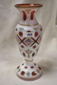 A 19th century Bohemian overlay glass vase, wheel-cut with apertures and painted with foliate