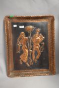An embossed and etched copper wall plaque, depicting traditionally attired figures to centre.
