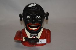 A vintage cast metal Jolly Gent mechanical money box.
