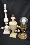 An alabaster table lamp, a cream onyx classical form table lamp, and another, the tallest