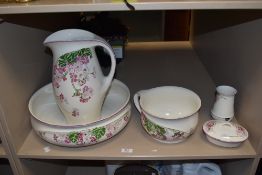 A Dutch Societe Ceramique Maestricht lustre wash jug and bowl, decorated with a floral spray