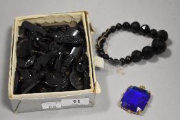 A selection of antique black loose beads and buttons etc, also included is a blue pendant.