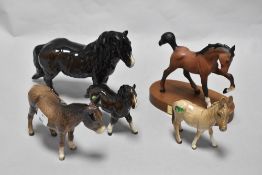 A group of Beswick pottery studies, including donkeys and pony, also horse on plinth, springtime, in